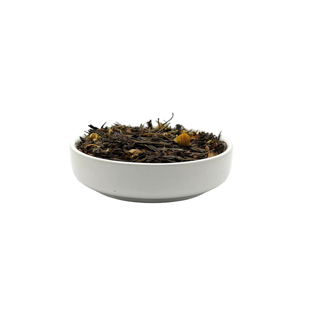 Side view of Green Tea Garden blend featuring green tea, chamomile, and botanicals in a white bowl