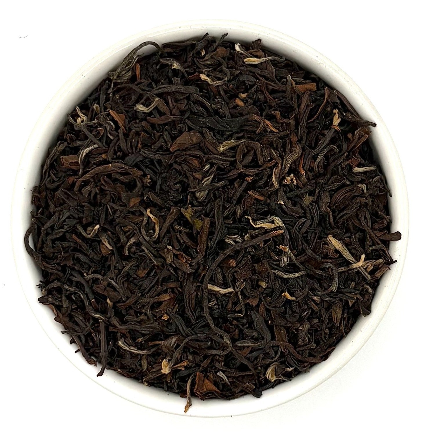 Top-down view of rolled Mountain Copper Oolong tea leaves showing dark brown and golden hues