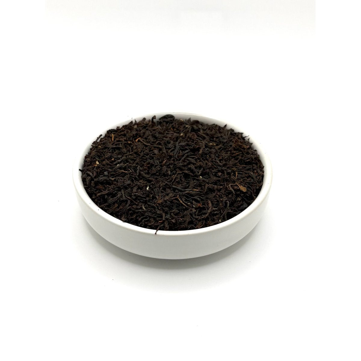 Angled view of Assam Banaspati loose black tea with bold, twisted leaves