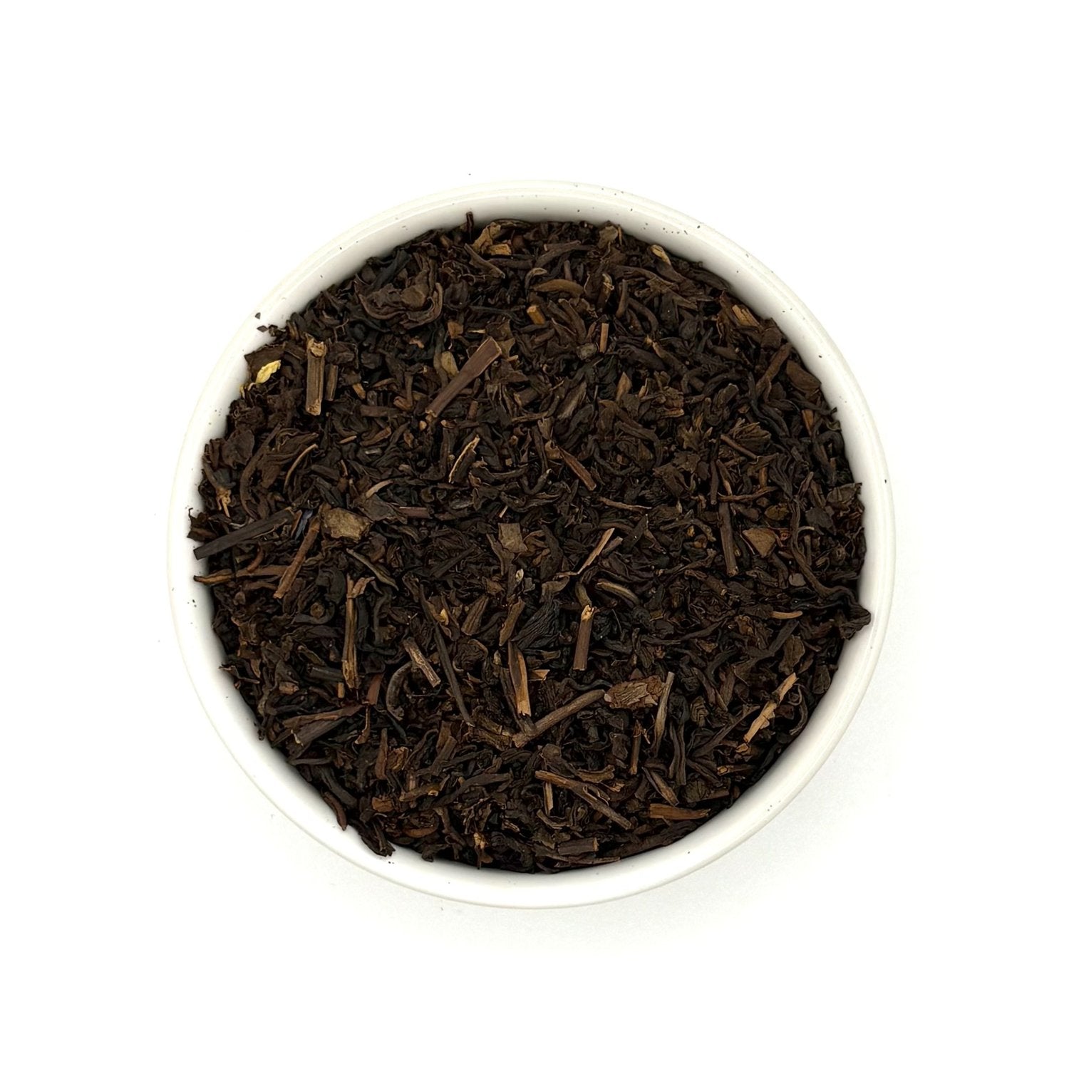 Top-down view of Decaf Earl Grey black tea leaves in a round white bowl
