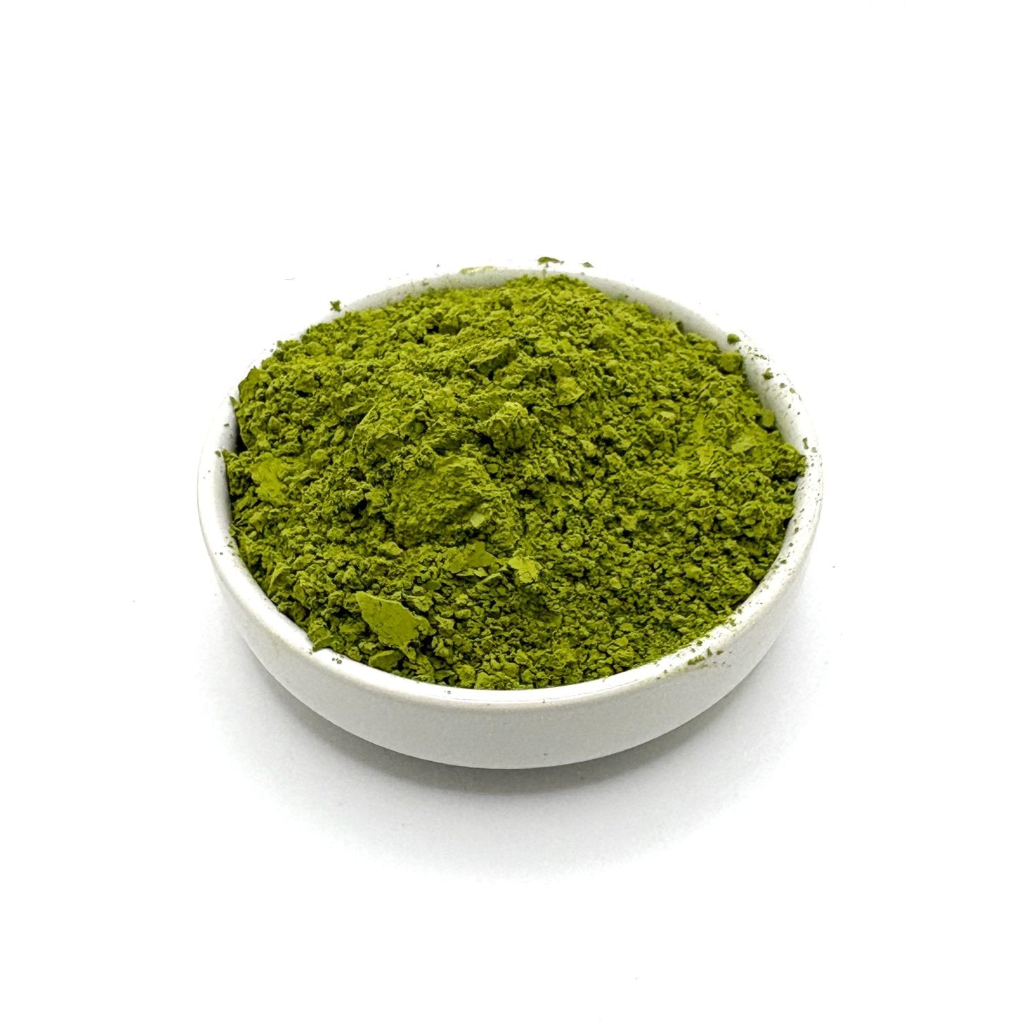 Angled view of vibrant ceremonial matcha powder in ceramic bowl